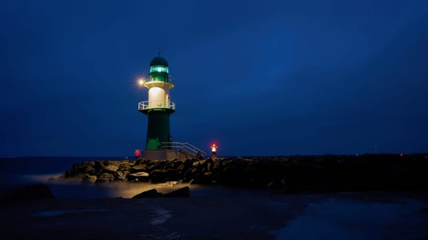 The lighthouse Molenfeuer on the western pier at the coast of Warnemuende in Germany
