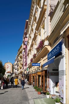Tourists in a popular shopping street in the old town of Karlovy Vary in the Czech Republic
