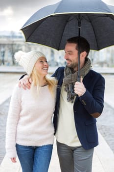 View of a Portrait of a young couple on holidays under the rain