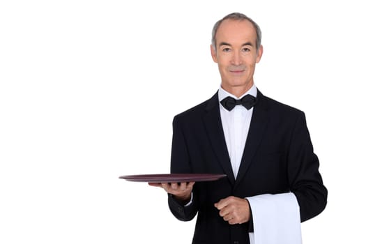 waiter in tuxedo holding a plate
