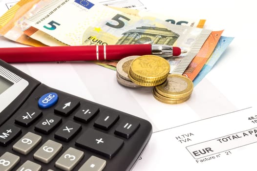 Close up of invoice with calculator and pen. Ball with money, paper on a white background