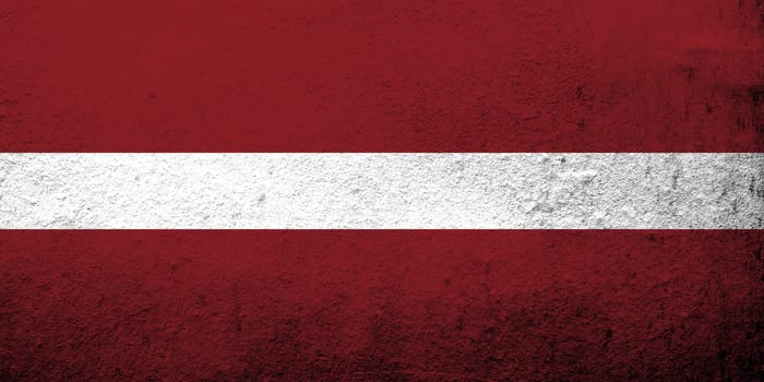 The Republic of Latvia National flag. Grunge background