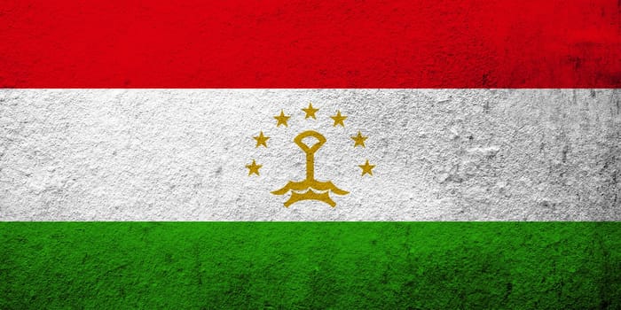 The Republic of Tajikistan National flag. Grunge background