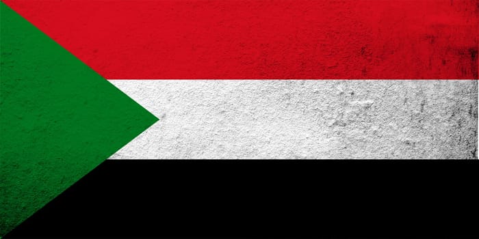 the Republic of the Sudan National flag. Grunge background