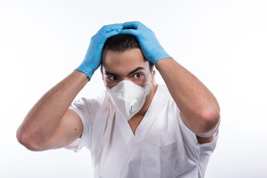 Young male nurse man in blue sterile gloves. A pandemic epidemic that spreads the concept of the flu virus coronavirus.