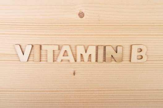 Term from wooden letters on pale wood
