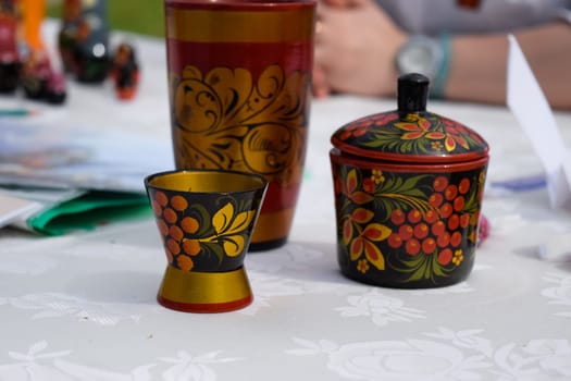 A wooden painted glass and a sugar bowl on the table. Russian Art