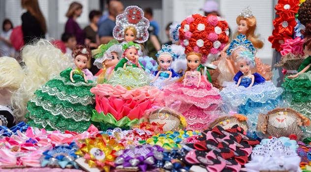 Krasnodar, Russia - May 1, 2019: Dolls girls in multi-colored dress. Dolls girls in multi colored dress