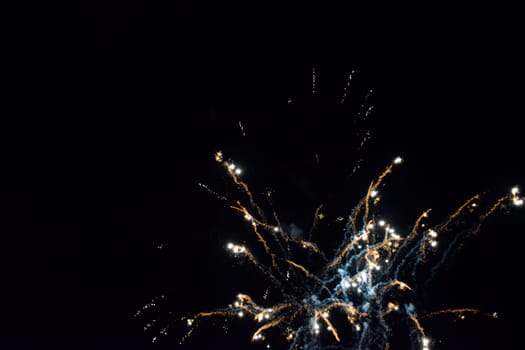 Festive salute in the night sky. Explosions of fireworks and pyrotechnics in the sky.