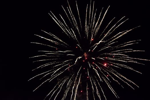 Festive salute in the night sky. Explosions of fireworks and pyrotechnics in the sky.