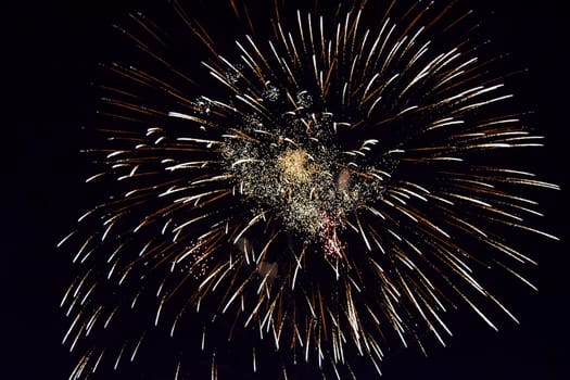Festive salute in the night sky. Explosions of fireworks and pyrotechnics in the sky.