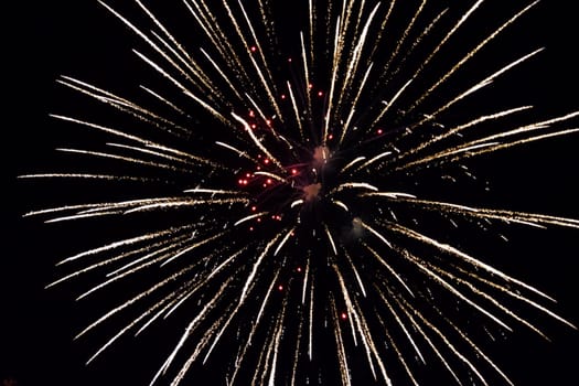 Festive salute in the night sky. Explosions of fireworks and pyrotechnics in the sky.