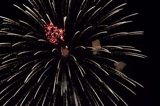 Festive salute in the night sky. Explosions of fireworks and pyrotechnics in the sky.