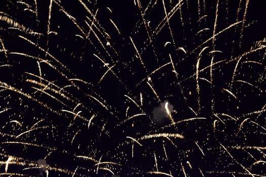 Festive salute in the night sky. Explosions of fireworks and pyrotechnics in the sky.