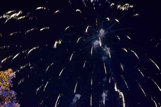 Festive salute in the night sky. Explosions of fireworks and pyrotechnics in the sky.
