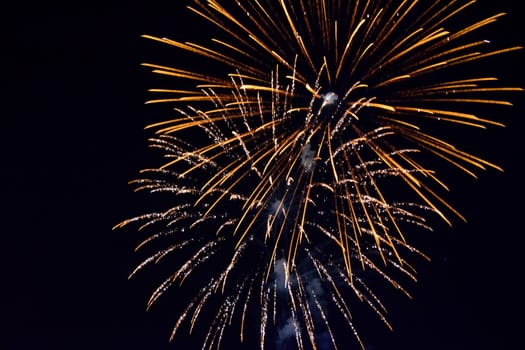 Festive salute in the night sky. Explosions of fireworks and pyrotechnics in the sky.