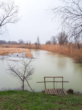 A makeshift pier by the pond. Autumn landscape