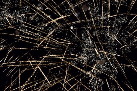 Festive salute in the night sky. Explosions of fireworks and pyrotechnics in the sky.