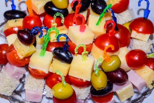 a Salad assorted, on plastic sticks vegetables and cheese.