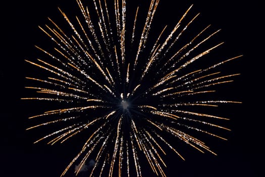 Festive salute in the night sky. Explosions of fireworks and pyrotechnics in the sky.