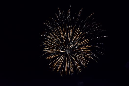 Festive salute in the night sky. Explosions of fireworks and pyrotechnics in the sky.