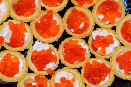 Waffle cups with mayonnaise and red caviar. Waffle cups with mayonnaise and red caviar.