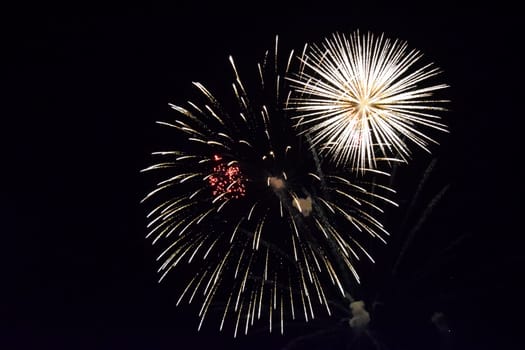 Festive salute in the night sky. Explosions of fireworks and pyrotechnics in the sky.