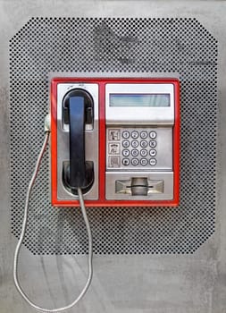 Public telephone with metal keypad dial