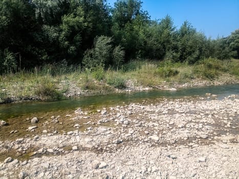 A shallow mountain river, the bottom of a mountain river of stones and gravel.