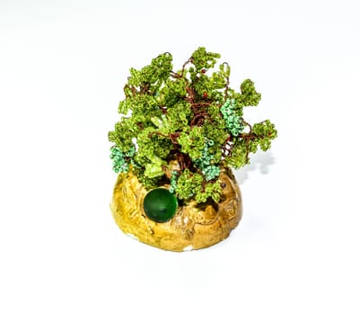 Creative wood made of copper wire and green beads.