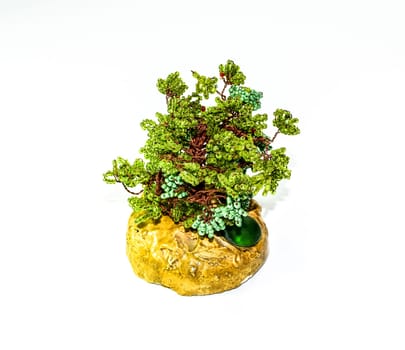 Creative wood made of copper wire and green beads.