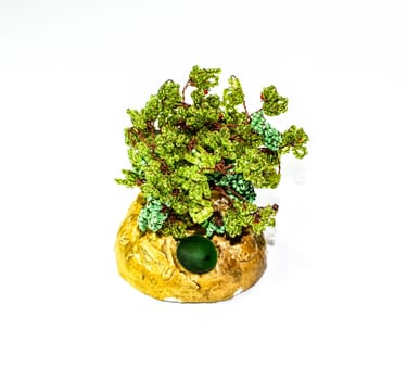 Creative wood made of copper wire and green beads.