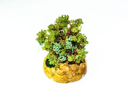 Creative wood made of copper wire and green beads.