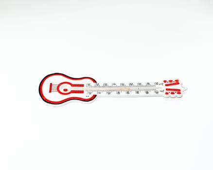 Alcohol thermometer with a red scale. Guitar shaped thermometer on a white background.