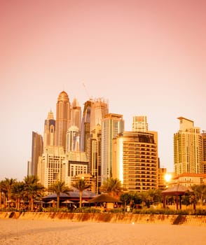 View of Dubai Marina skyscrapers from the seaside at sunset. Dubai, UAE