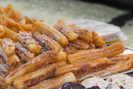 sweet churros and alfajores for sale at the street fair