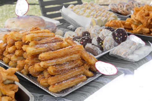 sweet churros and alfajores for sale at the street fair