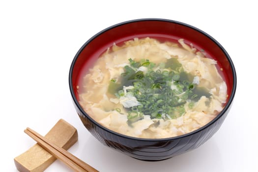Japanese foof, Tokitama egg soup in a wooden bowl with chopsticks on white background　