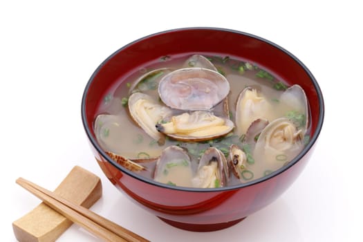 Japanese miso soup with asari clams in a bowl on white background