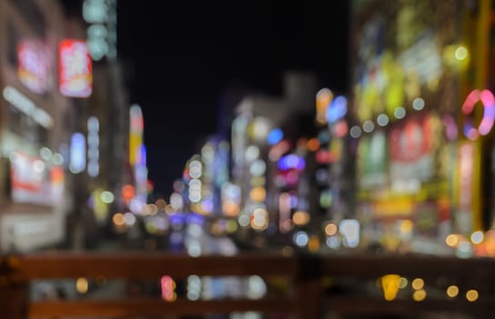 Abstract blur Illuminated billboards of store and restaurant at night in Osaka, Japan