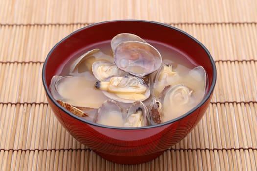 Japanese miso soup with asari clams in a bowl on bamboo table