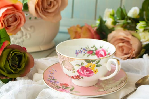 Vintage tea cup, frame of pastel roses flowers