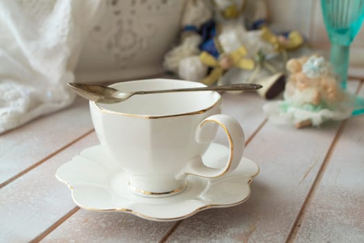 Closeup of white cup of tea on vintage wooden table
