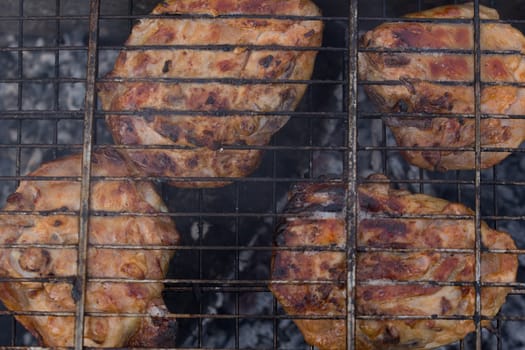Delicious meat, grilled on a grill with a delicious crust cooked in the open air