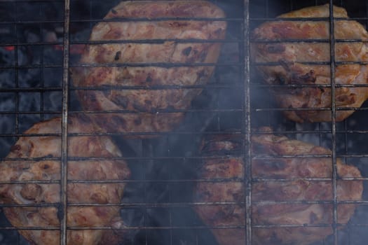 Delicious meat, grilled on a grill with a delicious crust cooked in the open air