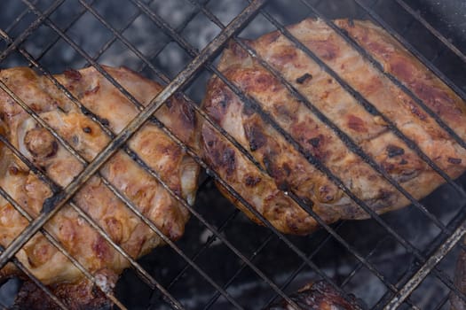 Delicious meat, grilled on a grill with a delicious crust cooked in the open air