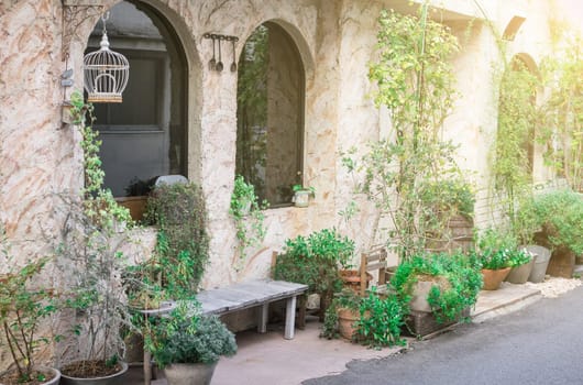 The view of the beautiful outside side of the house and the side door visible to the small walkway.