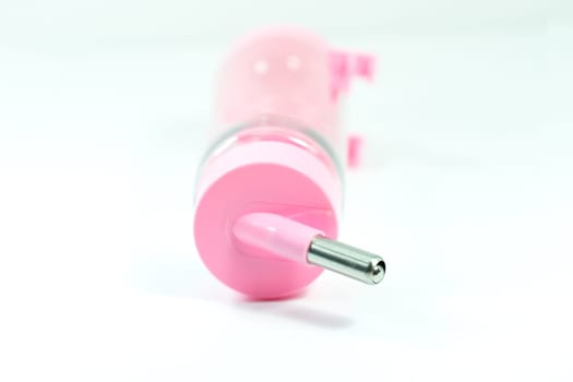 Pet supplies about water feeder of pink for dog or cat isolated on white