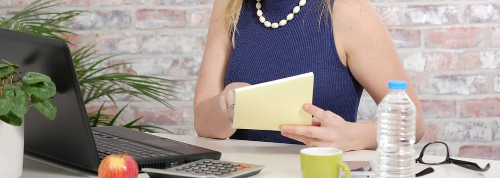 Close up hands of Business woman wearing a blue shirt.