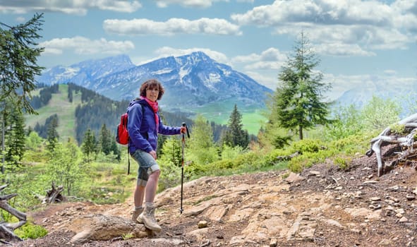 a woman hiker on a trail in the French Alps